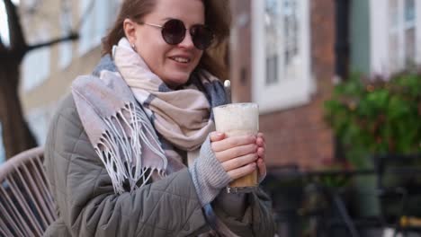 woman enjoying a warm latte outdoors