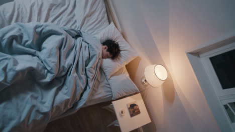 young man sleeping peacefully in bed
