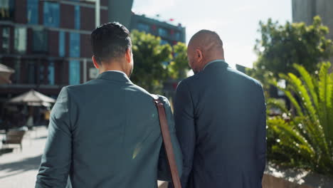 businessmen in conversation outdoors