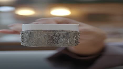 a hand holding a traditional turkish coffee cup