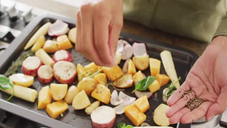 Video of midsection of biracial woman preparing meal, adding herbs