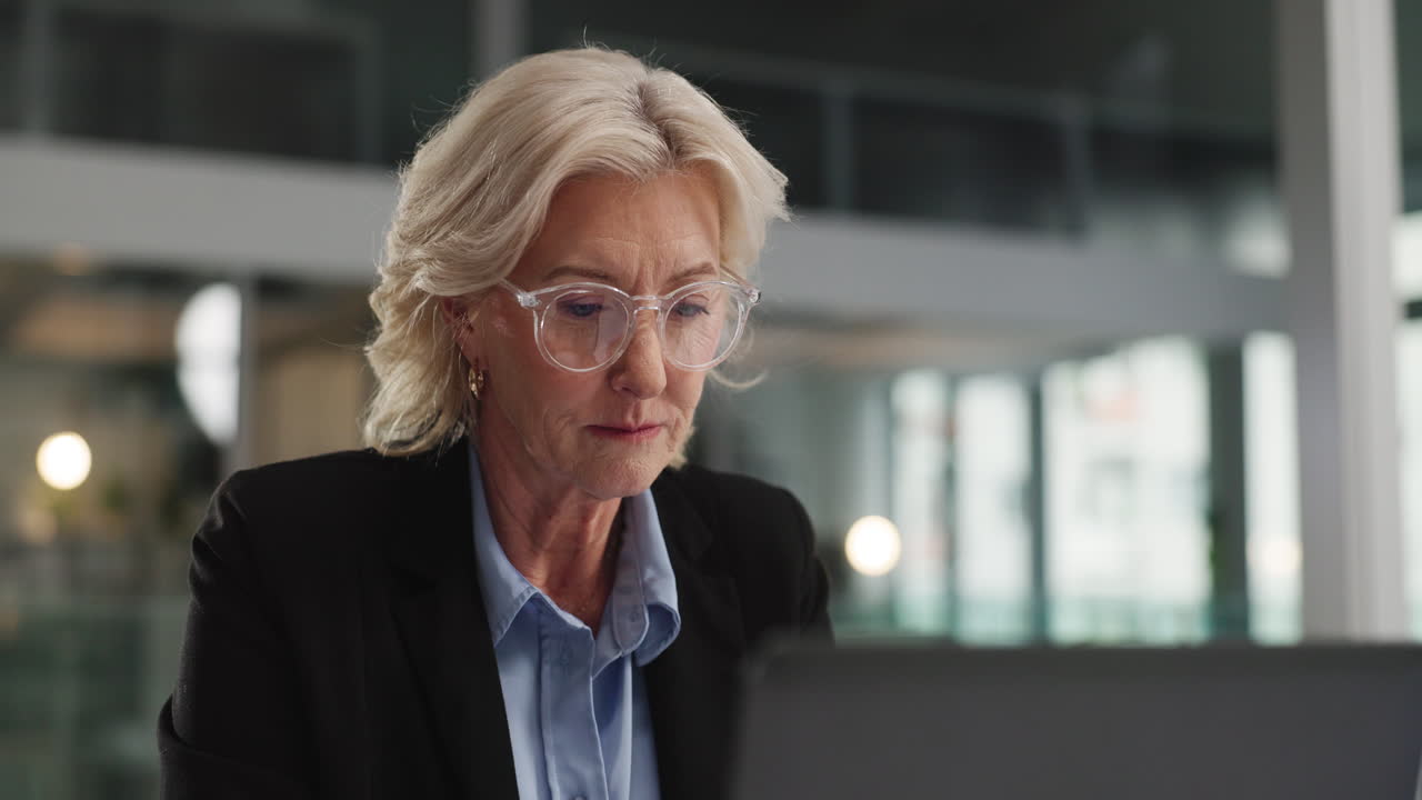 A mature businesswoman working on a laptop