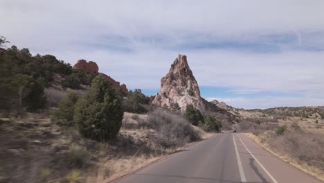 driving on the road through the colorado garden of the gods park in colorado springs, colorado, usa. pov shot