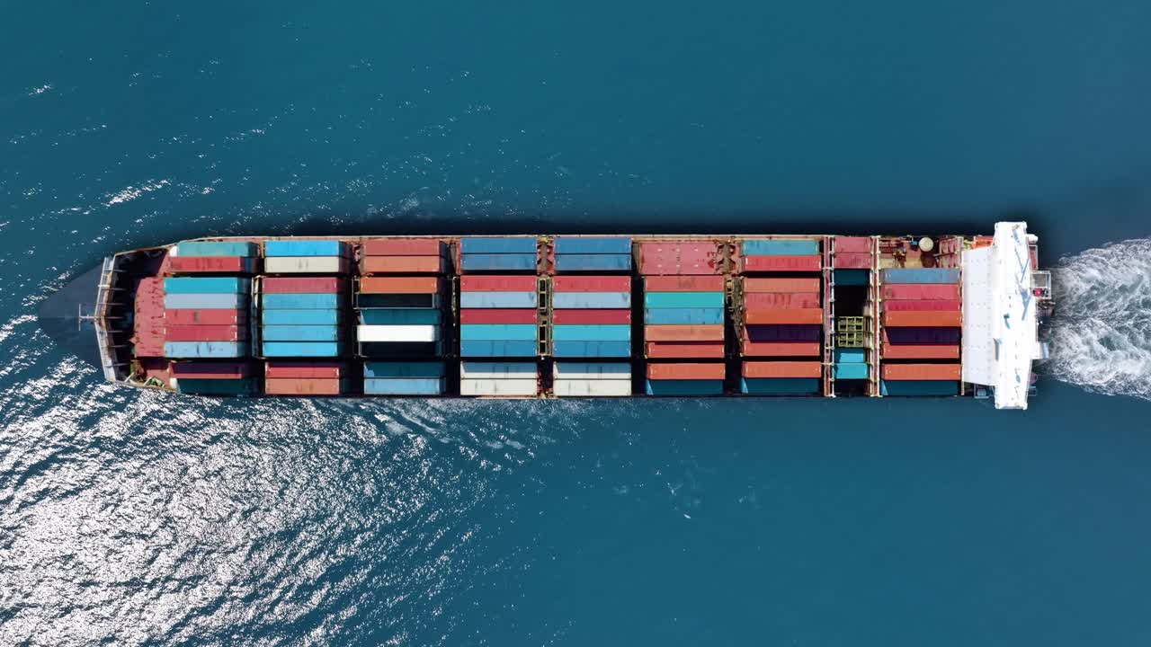 Container ship sailing through clear waters, transporting valuable cargo across major trade routes for international shipping markets