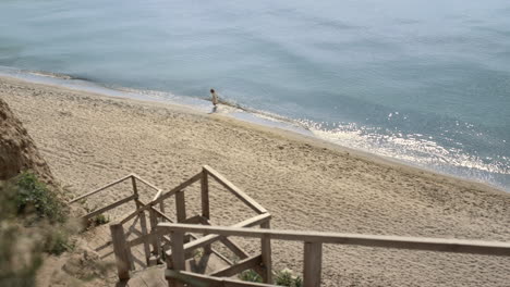 Energetic-woman-running-ocean-waves-view-in-distance.-Girl-have-fun-walking.