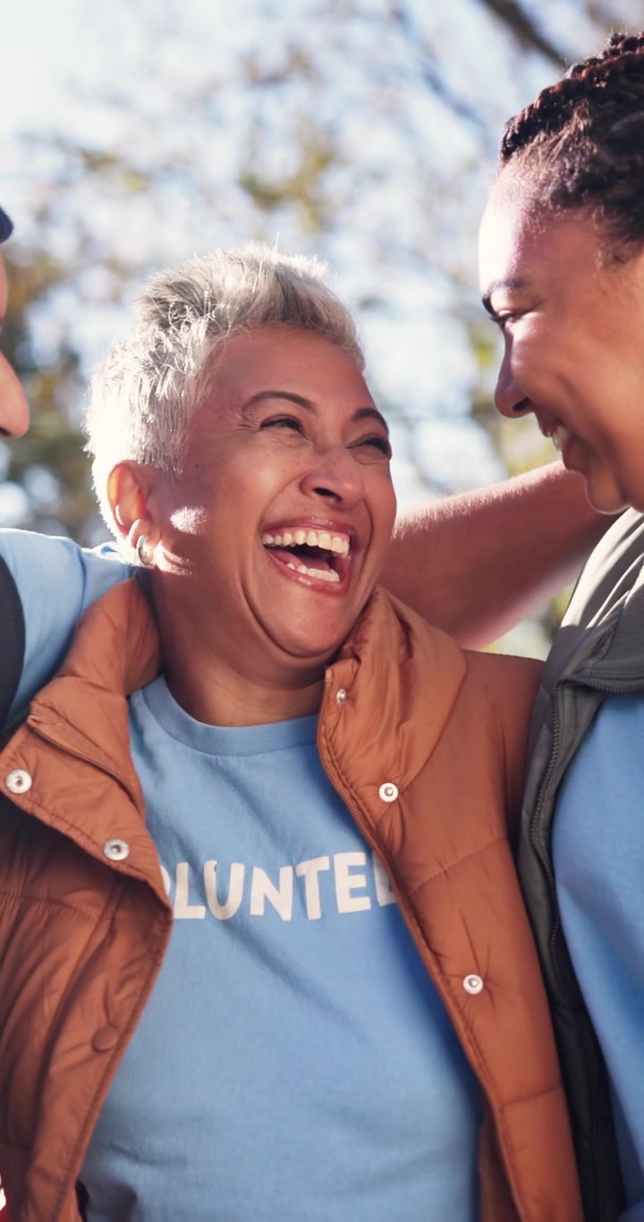 Group of Diverse Volunteers Laughing Together Outdoors