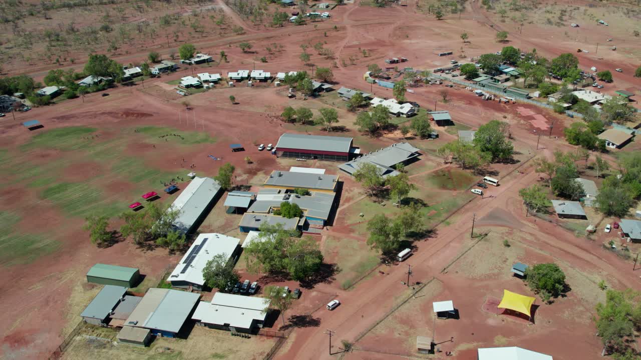 Reverse aerial footage over the Kalkarindji School and the communtiy of Kalkarindji, Gurindji, Northern Territory, Australia, August 2022.