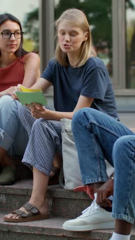 students discussing on campus stairs