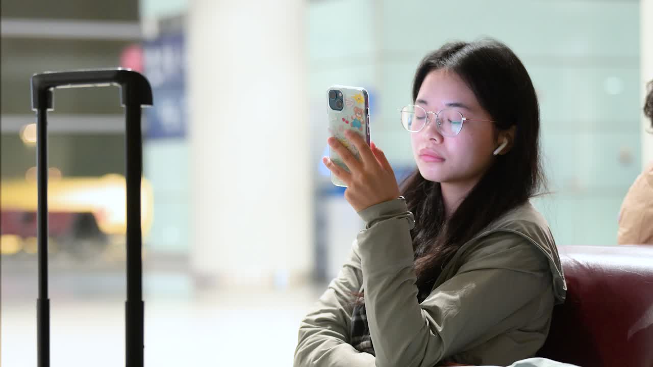 Young Woman Using Phone at Airport