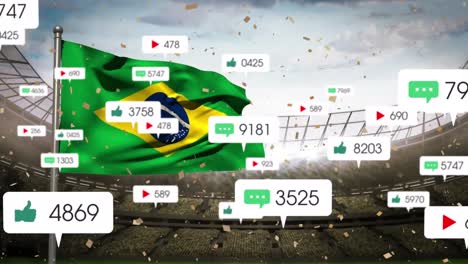 Animation-Von-Social-Media-Symbolen-Und-Konfetti,-Die-über-Die-Wehende-Brasilianische-Flagge-Gegen-Das-Sportstadion-Fallen