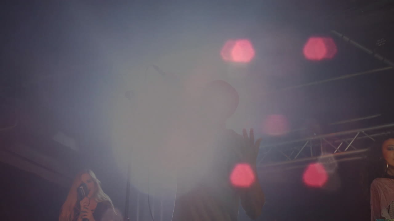 band members performing on concert stage, showing animated lens flare overlays for music industry