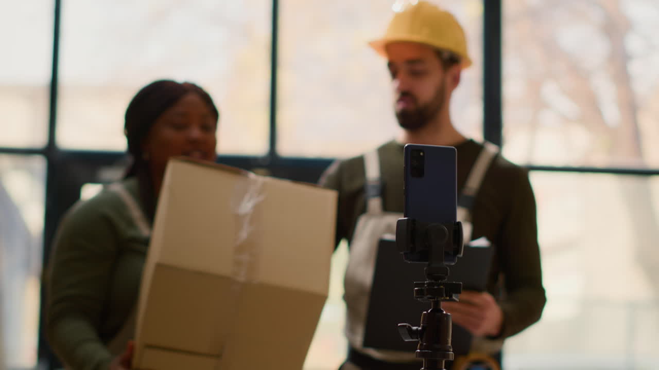 Construction workers using mobile phone for video conference