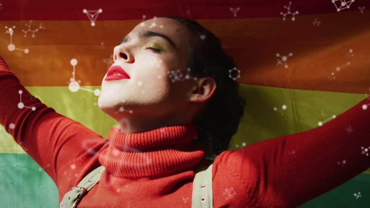 Woman holding arms out molecules rising over pride flag causing closing eyes tilting up for health