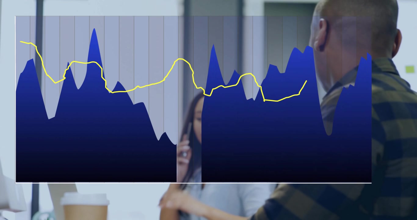 Chart overlay fading revealing coworkers speaking on phone, typing laptop for office collaboration
