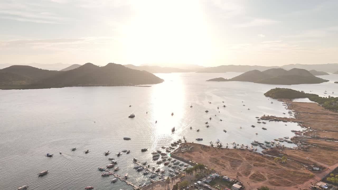 Bird's-eye survey of Coron Town at sunset, the beach, the boats, the water under the sun, Coron, Philippines