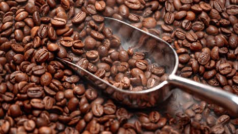 Close-up-of-seeds-of-coffee.-Fragrant-coffee-beans-are-roasted-smoke-comes-from-coffee-beans.