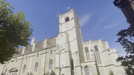 shot of a large church in france in the sun in france in the small town