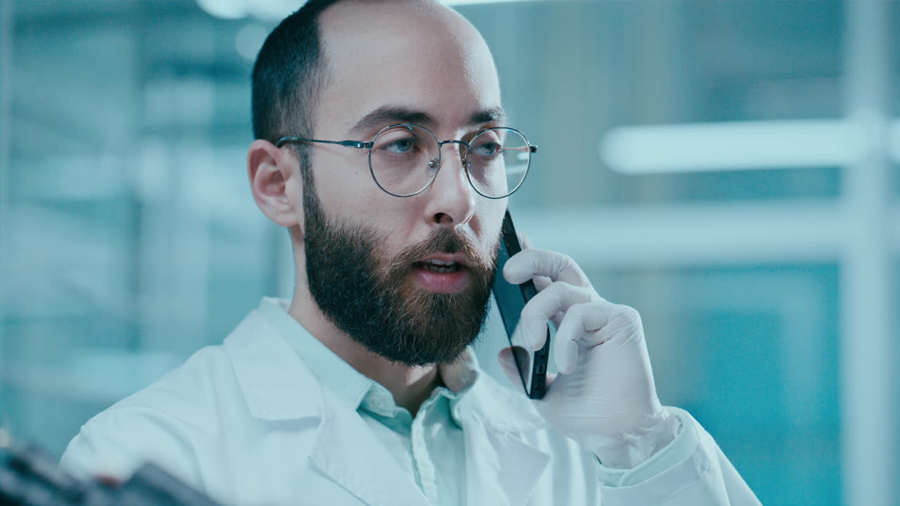 Scientist Having Phone Conversation during Workday in Laboratory