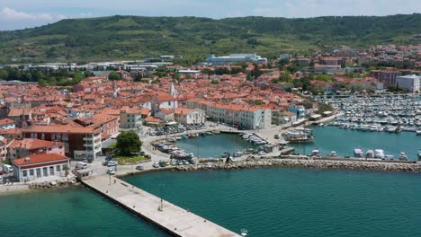 aerial arc shot focused around the marina in izola, slovenia on a bright afternoon