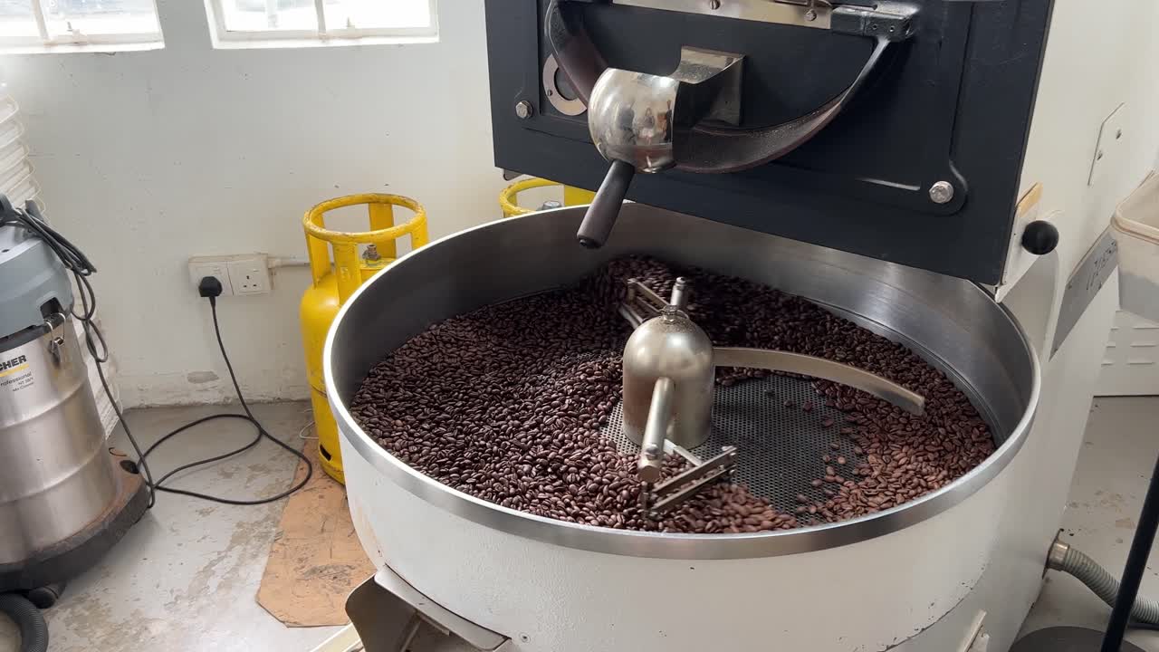 Production warehouse factory shot of food and beverage industry, aromatic specialty coffee beans on cooling and mixing tray to reduce the heat evenly after roasting