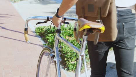 man walking along with the bicycle in city 4k