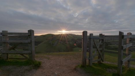 sunrise over corfe castle, slow zoom in on castle with moving clouds