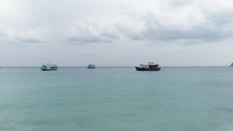 boats in the turquoise water on a cloudy day