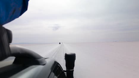 car driving through the salar de uyuni - uyuni salt flat in bolivia. - pov