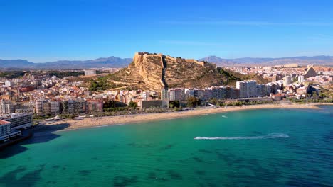 playa de postiguet in alicante spain with the castillo de santa barbara in the background