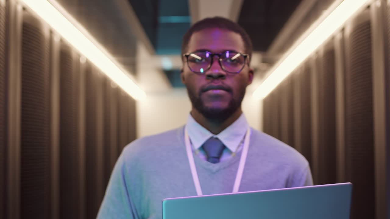 Professional IT Engineer Walking along Modern Server Room