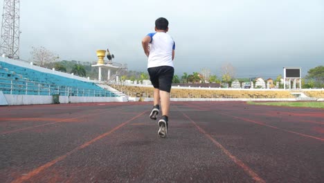 boy running in stadium