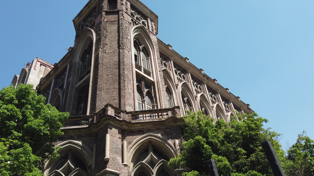 Low angle details of neo gothic architecture Facade Engineering University Building in Buenos Aires, Urban Park Setting at Daylight