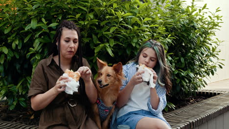 family and dog enjoying lunch outdoors