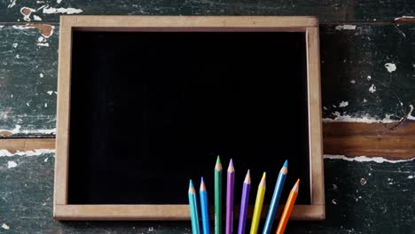 color pencils and slate arranged on table