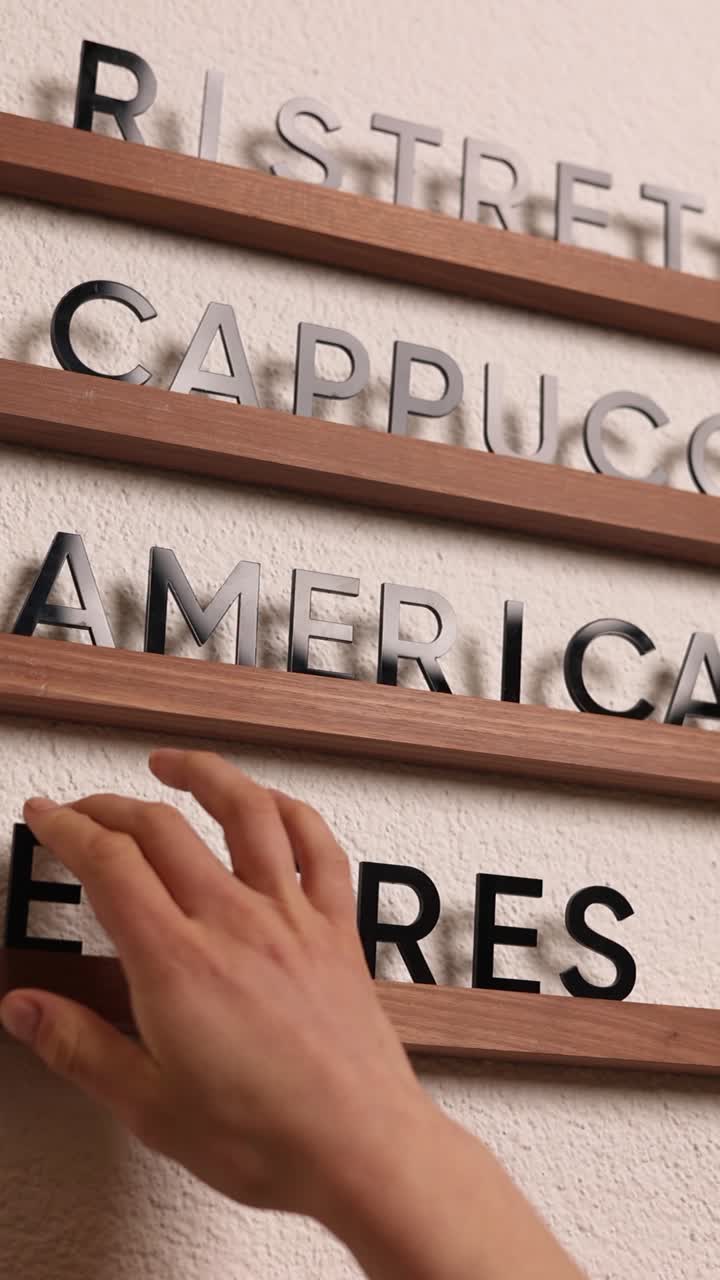 Hand touching coffee drink selection on menu board