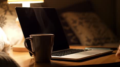 a cozy evening work setup: warm mug, laptop, and soft lighting create a relaxing atmosphere for late-night productivity and inspiration