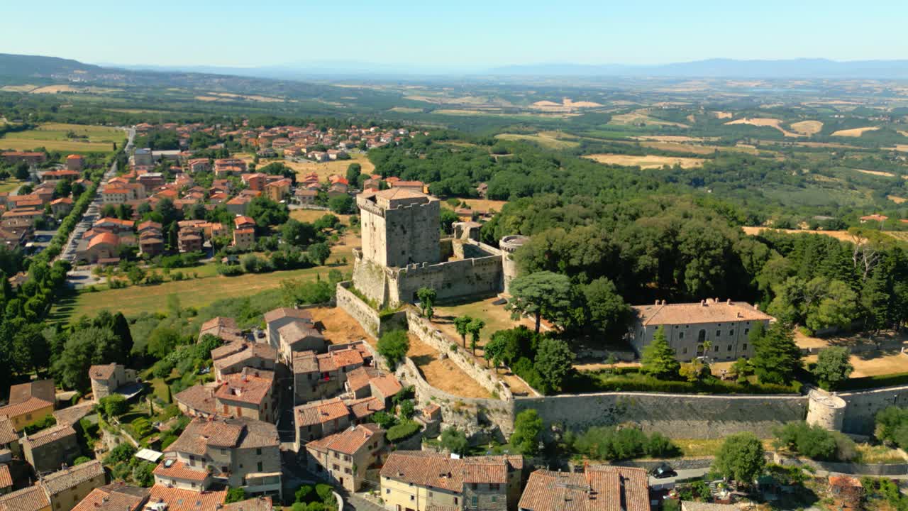 Medieval castello di sarteano dominating picturesque tuscan landscape, surrounded by rolling hills and verdant greenery, showcasing historic architectural grandeur from sweeping aerial perspective