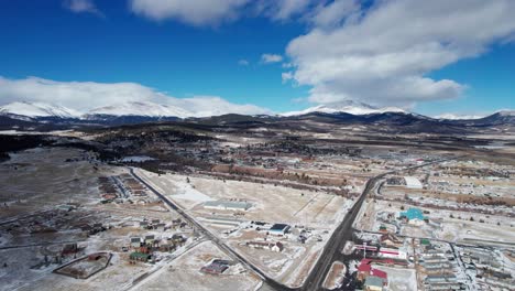 Drone-Aerial-View-of-Fairplay,-CO-on-a-sunny-winter-day-with-mountain-peaks
