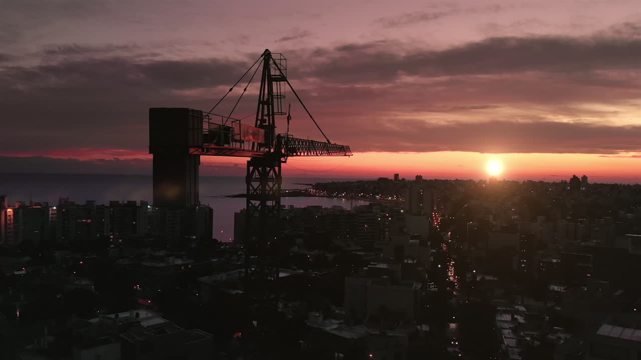 grúa de construcción en la ciudad al atardecer
