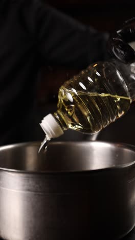 pouring oil into a pan