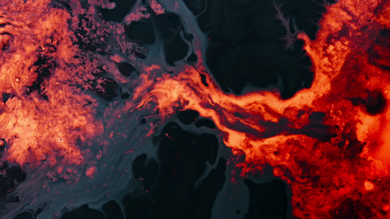 Bright liquid dissolving in dark fluid, creating abstract patterns, macro view