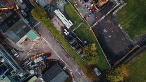 Futuristic-looking-aerial-drone-footage,-with-a-steampunk,-science-fictional-look-with-industrial-buildings-and-vehicles