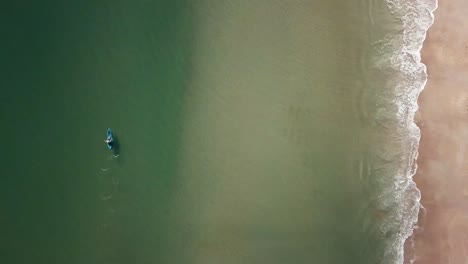 Drone-flight-over-a-kayker-on-a-beach-in-Florida