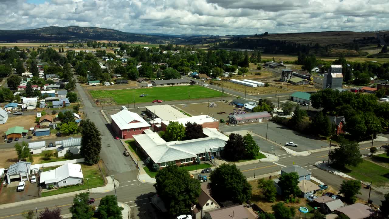 US, Oregon, Elgin, 2025-08-07 - Drone view of a Life Flight helicopter landed in a grass field
