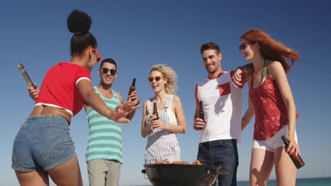 young adult friends having a barbecue on a beach 4k