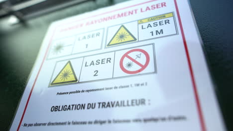 a panning shot of a white sign board in the factory which denotes something about machines