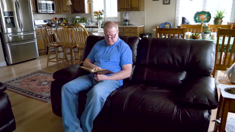 a man sits down to enjoy reading a novel