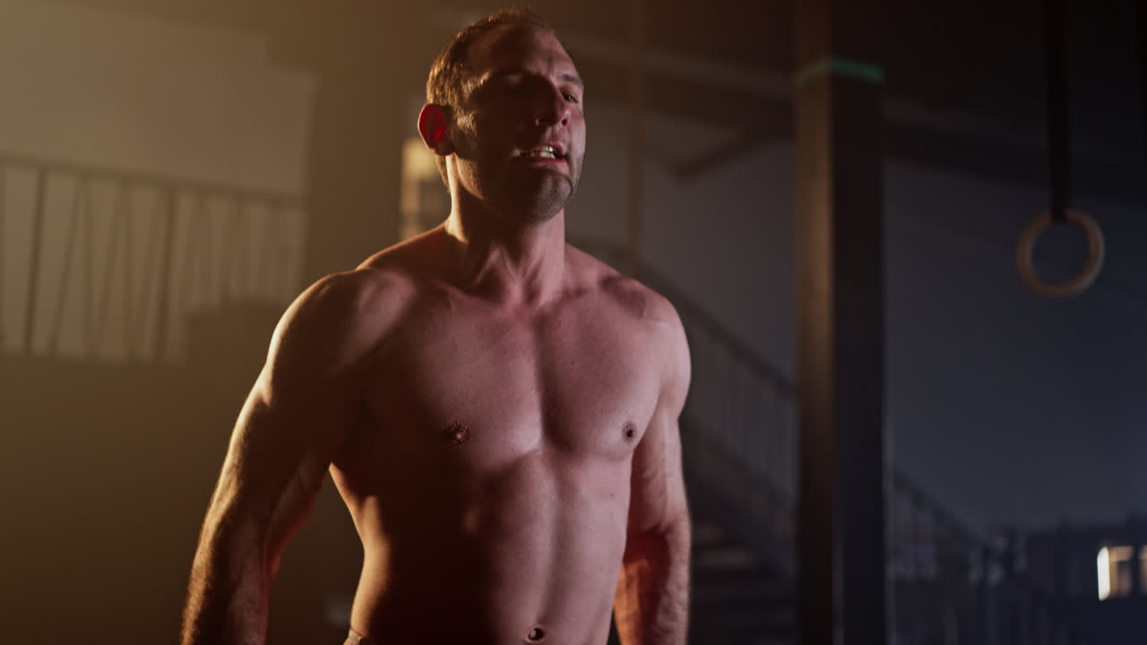 Shirtless muscular man working out in gym