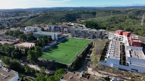 sunlit flight over la mosson reveals the lush green soccer field, ready for the