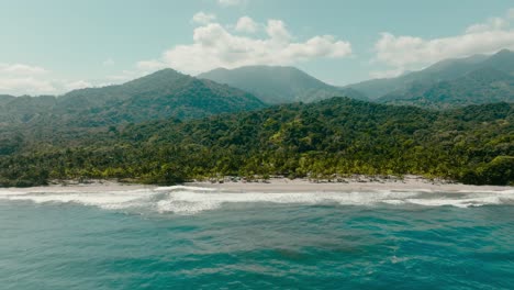 aerial view flying towards the mountains and sea, colombia